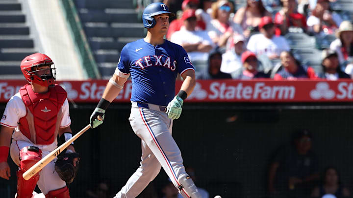 Sep 29, 2024; Anaheim, California, USA;  Texas Rangers first baseman Nathaniel Lowe (30) hits a home run during the eighth inning against the Los Angeles Angels at Angel Stadium. 