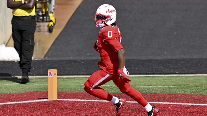 Oct 18, 2025; Houston, Texas, USA; Houston Cougars wide receiver Amare Thomas (0) runs the ball for a touchdown during the first quarter against the Arizona Wildcats at TDECU Stadium. Mandatory Credit: Maria Lysaker-Imagn Images 