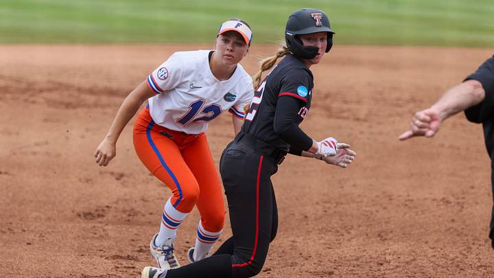 Florida infielder Kendall Grover (12) and Texas Tech shortstop Hailey Toney (32) watch the pass ball at third during game 3 of the super regional of the NCAA Division 1 softball championship at Katie Seashole Pressly Stadium in Gainesville, FL on Sunday, May 24, 2026. [Alan Youngblood/Gainesville Sun]