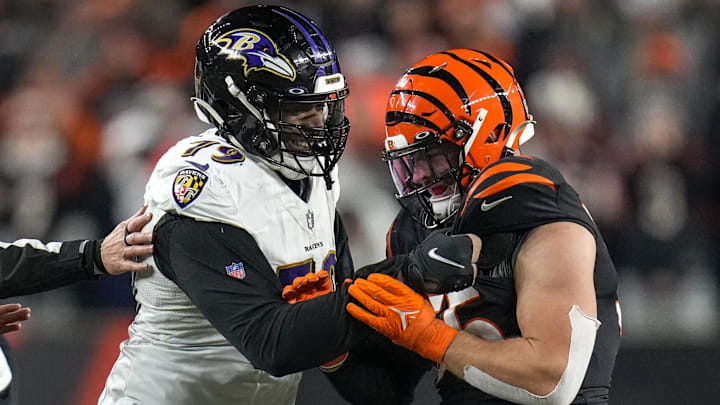 Jan 15, 2023; Cincinnati, Ohio, USA; Baltimore Ravens offensive tackle Ronnie Stanley (79) grips the jersey of Cincinnati Bengals linebacker Logan Wilson (55) after a play in the fourth quarter during an NFL wild-card playoff football game between the Baltimore Ravens and the Cincinnati Bengals at Paycor Stadium. Mandatory Credit: Sam Greene-Imagn Images
