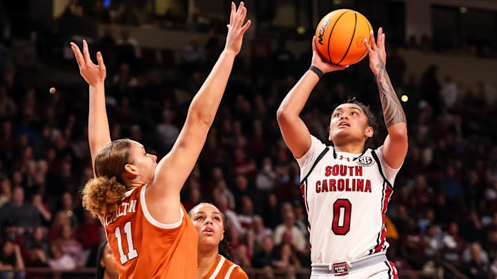 Jan 12, 2025; Columbia, South Carolina, USA; South Carolina Gamecocks guard Te-Hina Paopao (0) drives past Texas Longhorns forward Justice Carlton (11) in the first half at Colonial Life Arena. Mandatory Credit: Jeff Blake-Imagn Images