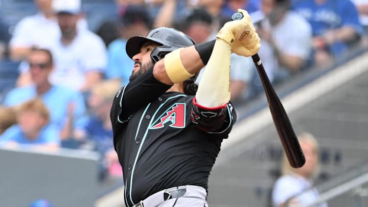 Jun 19, 2025; Toronto, Ontario, CAN;  Arizona Diamondbacks third baseman Eugenio Suarez (28) hits a two run home run against the Toronto Blue Jays in the second inning at Rogers Centre. Mandatory Credit: Dan Hamilton-Imagn Images
