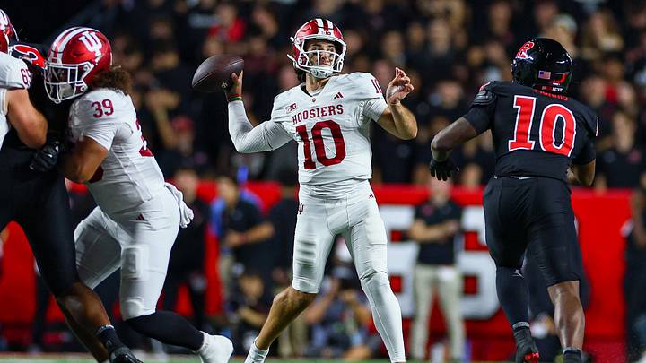 Oct 3, 2026; Piscataway, New Jersey, USA; Indiana Hoosiers quarterback Josh Hoover (10) throws the ball during the first half as Rutgers Scarlet Knights linebacker Ty Morris (10) pursues at SHI Stadium. Mandatory Credit: Vincent Carchietta-Imagn Images