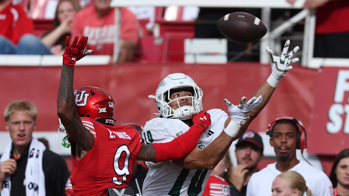 Utah Utes cornerback Elijah Davis (9) and Cal Poly Mustangs wide receiver Michael Briscoe (10) battle for a pass during the second quarter at Rice-Eccles Stadium.