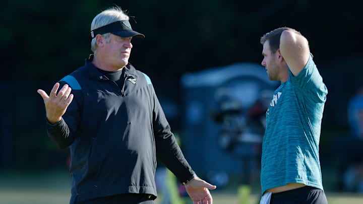 Jacksonville Jaguars head coach Doug Pederson talks with offensive coordinator Press Taylor on the