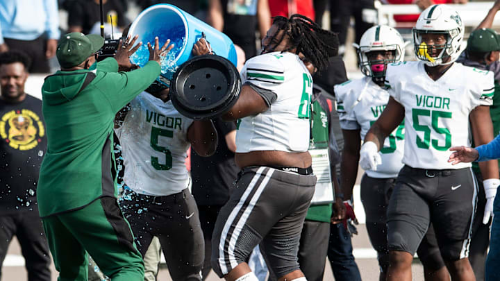 Vigor coach John McKenzie resists a bath after the game during the Class 4A football state championship at Protective Stadium in Birmingham, Ala., on Friday, Dec. 3, 2021. Vigor defeats Oneonta 52-14.