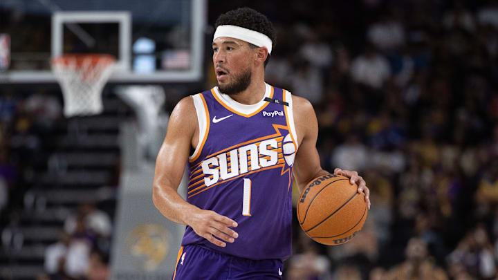 Oct 6, 2024; Palm Desert, California, USA; Phoenix Suns guard Devin Booker (1) moves the ball against the Los Angeles Lakers during the first half at Acrisure Arena. Mandatory Credit: David Frerker-Imagn Images