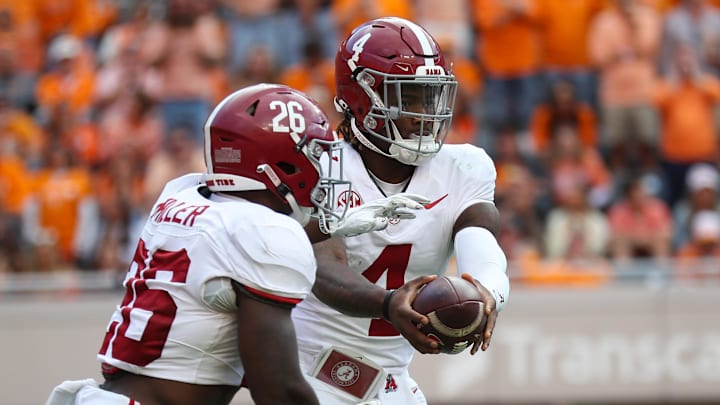 Oct 19, 2024; Knoxville, Tennessee, USA; Alabama Crimson Tide quarterback Jalen Milroe (4) hands the ball off to running back Jam Miller (26) against the Tennessee Volunteers during the second quarter at Neyland Stadium. Oct 19, 2024; Knoxville, Tennessee, USA; Alabama Crimson Tide quarterback Jalen Milroe (4) hands the ball off to running back Jam Miller (26) against the Tennessee Volunteers during the second quarter at Neyland Stadium.