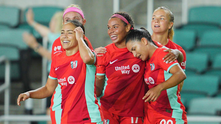 Aug 6, 2024; Kansas City, MO, USA; Kansas City Current midfielder Debinha (99) celebrates a goal with teammates in the second half against the North Carolina Courage  at CPKC Stadium. Mandatory Credit: Jay Biggerstaff-USA TODAY Sports