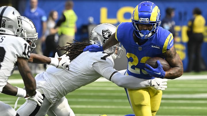 Oct 20, 2024; Inglewood, California, USA; Los Angeles Rams running back Kyren Williams (23) tries to break a tackle by Las Vegas Raiders safety Tre'von Moehrig (7) during the third quarter at SoFi Stadium. Mandatory Credit: Robert Hanashiro-Imagn Images