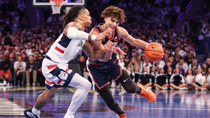 Nov 28, 2025; New York, New York, USA;  Illinois Fighting Illini guard Keaton Wagler (23) looks to drive past UConn Huskies guard Solo Ball (1) in the second half at Madison Square Garden. Mandatory Credit: Wendell Cruz-Imagn Images