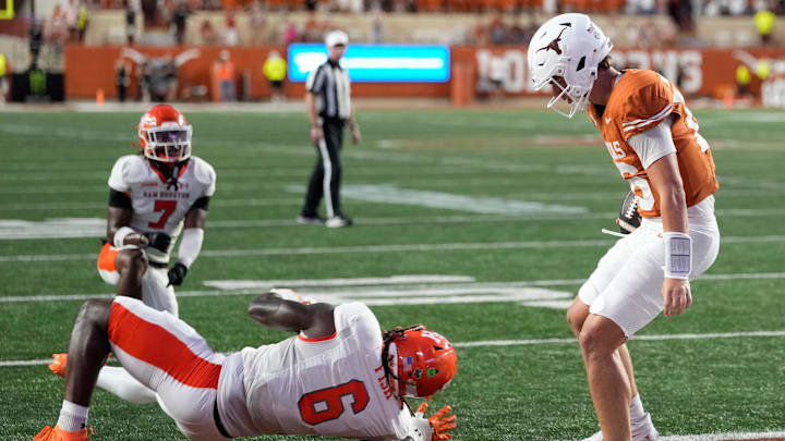 Texas Longhorns quarterback Arch Manning (16) runs in for a touchdown past Sam Houston Bearkats linebacker Antivirus Fish (6) during the first half at Darrell K Royal-Texas Memorial Stadium.