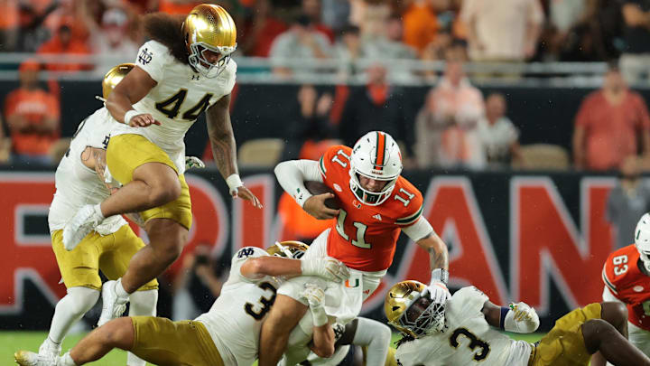 Aug 31, 2025; Miami Gardens, Florida, USA; Miami Hurricanes quarterback Carson Beck (11) rushes the ball against the Notre Dame Fighting Irish during the second quarter at Hard Rock Stadium. Mandatory Credit: Sam Navarro-Imagn Images