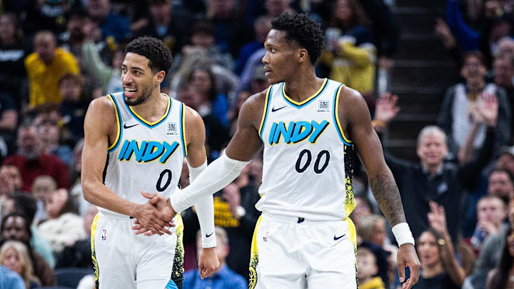 Dec 31, 2024; Indianapolis, Indiana, USA; Indiana Pacers guard Bennedict Mathurin (00) celebrates a made shot with  guard Tyrese Haliburton (0)  in the second half against the Milwaukee Bucks at Gainbridge Fieldhouse. Mandatory Credit: Trevor Ruszkowski-Imagn Images