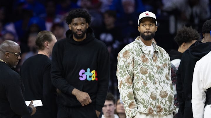 Nov 2, 2024; Philadelphia, Pennsylvania, USA; Injured Philadelphia 76ers Paul George (R) and Joel Embiid (L) look on during the first quarter against the Memphis Grizzlies at Wells Fargo Center. Mandatory Credit: Bill Streicher-Imagn Images Nov 2, 2024; Philadelphia, Pennsylvania, USA; Injured Philadelphia 76ers Paul George (R) and Joel Embiid (L) look on during the first quarter against the Memphis Grizzlies at Wells Fargo Center. Mandatory Credit: Bill Streicher-Imagn Images