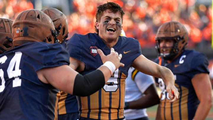 Oct 19, 2024; Champaign, Illinois, USA;  Illinois Fighting Illini quarterback Luke Altmyer (9) celebrates after scoring a touchdown against the Michigan Wolverines during the second half at Memorial Stadium. Mandatory Credit: Ron Johnson-Imagn Images