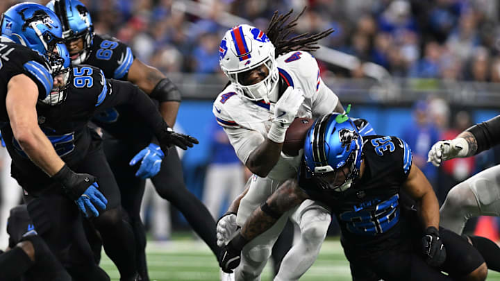 Buffalo Bills running back James Cook (4) tries to break a tackle from Detroit Lions safety Brian Branch (32). Buffalo Bills running back James Cook (4) tries to break a tackle from Detroit Lions safety Brian Branch (32).