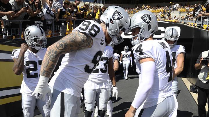 Sep 19, 2021; Pittsburgh, Pennsylvania, USA;  Las Vegas Raiders defensive end Maxx Crosby (98) and quarterback Derek Carr (4) prepare to take the field to play the Pittsburgh Steelers at Heinz Field. Mandatory Credit: Charles LeClaire-Imagn Images