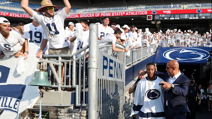 Penn State football coach James Franklin walks onto the field at Beaver Stadium in 2021 with former Nittany Lions running back Saquon Barkley. 