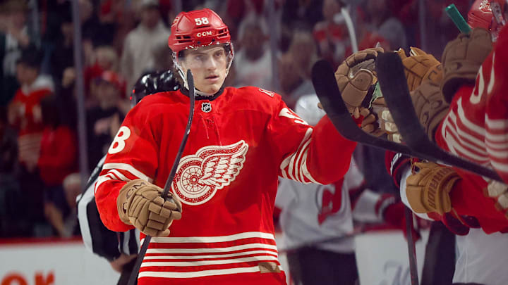 Apr 11, 2026; Detroit, Michigan, USA; Detroit Red Wings center Emmitt Finnie (58) receives congratulations from teammates after scoring in the third period against the New Jersey Devils at Little Caesars Arena. Mandatory Credit: Rick Osentoski-Imagn Images Apr 11, 2026; Detroit, Michigan, USA; Detroit Red Wings center Emmitt Finnie (58) receives congratulations from teammates after scoring in the third period against the New Jersey Devils at Little Caesars Arena. Mandatory Credit: Rick Osentoski-Imagn Images