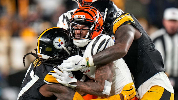 Cincinnati Bengals wide receiver Ja'Marr Chase (1) is wrapped up by Pittsburgh Steelers cornerback Cory Trice Jr. (27) on a reception in the fourth quarter of the NFL Week 18 game between the Pittsburgh Steelers and the Cincinnati Bengals at Acrisure Stadium in Pittsburgh on Saturday, Jan. 4, 2025. The Bengals won 19-17 to finish the regular season at 9-8. Cincinnati Bengals wide receiver Ja'Marr Chase (1) is wrapped up by Pittsburgh Steelers cornerback Cory Trice Jr. (27) on a reception in the fourth quarter of the NFL Week 18 game between the Pittsburgh Steelers and the Cincinnati Bengals at Acrisure Stadium in Pittsburgh on Saturday, Jan. 4, 2025. The Bengals won 19-17 to finish the regular season at 9-8.