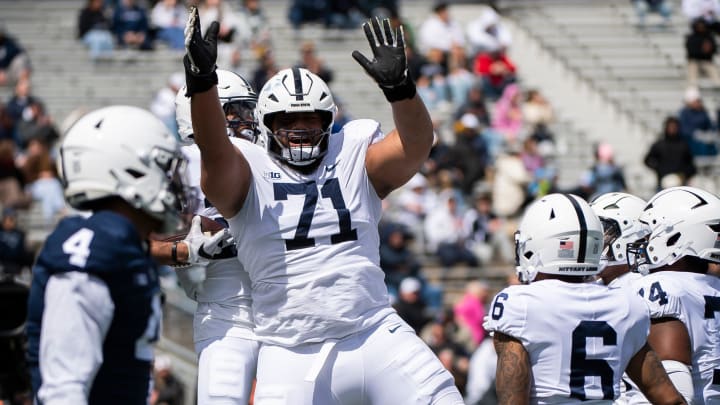 Penn State offensive lineman Vega Ioane celebrates with running back Quinton Martin Jr. after the freshman scored a touchdown during the Blue-White Game at Beaver Stadium.