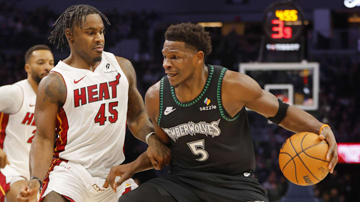 Jan 6, 2026; Minneapolis, Minnesota, USA; Minnesota Timberwolves guard Anthony Edwards (5) works around Miami Heat guard Davion Mitchell (45) in the first quarter at Target Center. Mandatory Credit: Bruce Kluckhohn-Imagn Images