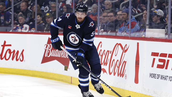 Apr 7, 2025; Winnipeg, Manitoba, CAN; Winnipeg Jets defenseman Dylan Samberg (54) skates up the ice against the St. Louis Blues in the first period at Canada Life Centre. Mandatory Credit: James Carey Lauder-Imagn Images