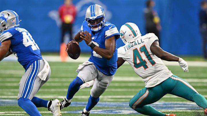 Aug 16, 2025; Detroit, Michigan, USA;  Detroit Lions quarterback Hendon Hooker (2) scrambles away from Miami Dolphins linebacker Channing Tidall (41) in the fourth quarter at Ford Field. Mandatory Credit: Lon Horwedel-Imagn Images