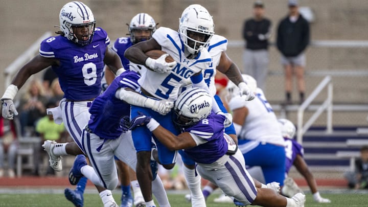 IMG Academy High School junior Winston Watkins Jr. (5) is stopped by Ben Davis High School defenders during the first half of an IHSAA varsity football game, Friday, Sept. 8, 2023, at Ben Davis High School.