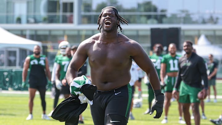 Jul 27, 2024; Florham Park, NJ, USA; New York Jets offensive tackle Olu Fashanu (74) runs up field greeting fans during training camp at Atlantic Health Jets Training Center. Jul 27, 2024; Florham Park, NJ, USA; New York Jets offensive tackle Olu Fashanu (74) runs up field greeting fans during training camp at Atlantic Health Jets Training Center.