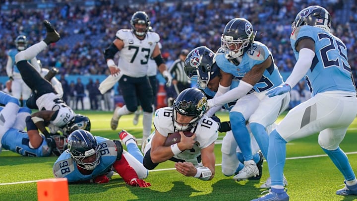 Jacksonville Jaguars quarterback Trevor Lawrence (16) dives in just short of the end zone as Tennessee Titans defensive tackle Jeffery Simmons (98), linebacker Jaylen Harrell (92) and safety Kevin Winston Jr. (23) pursue during the third quarter at Nissan Stadium in Nashville, Tenn., Sunday, Nov. 30, 2025. Jacksonville Jaguars quarterback Trevor Lawrence (16) dives in just short of the end zone as Tennessee Titans defensive tackle Jeffery Simmons (98), linebacker Jaylen Harrell (92) and safety Kevin Winston Jr. (23) pursue during the third quarter at Nissan Stadium in Nashville, Tenn., Sunday, Nov. 30, 2025.