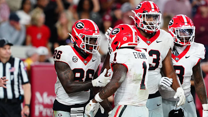 Sep 28, 2024; Tuscaloosa, Alabama, USA;  Georgia Bulldogs wide receiver Dillon Bell (86) celebrates with running back Trevor Etienne (1) after scoring a touchdown against the Alabama Crimson Tide during the fourth quarter at Bryant-Denny Stadium. Mandatory Credit: John David Mercer-Imagn Images