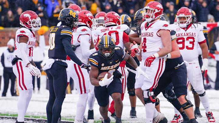 Nov 30, 2024; Columbia, Missouri, USA; Missouri Tigers running back Marcus Carroll (9) scores a touchdown against the Arkansas Razorbacks during the first half at Faurot Field at Memorial Stadium. Mandatory Credit: Denny Medley-Imagn Images