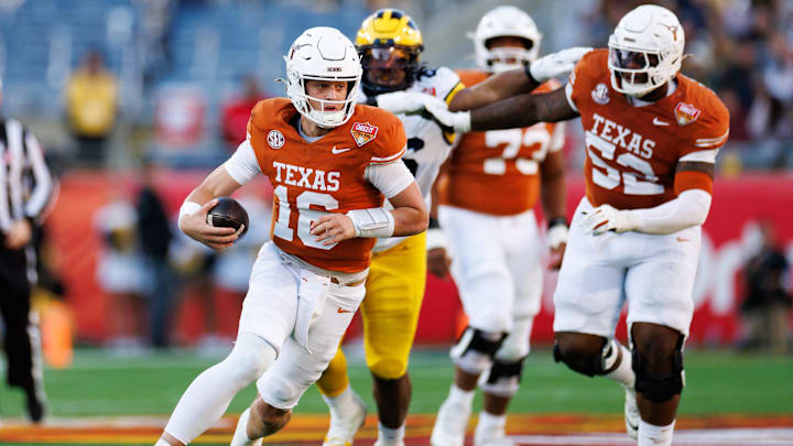 Dec 31, 2025; Orlando, FL, USA; Texas Longhorns quarterback Arch Manning (16) runs with the ball against the Michigan Wolverines during the first half at Camping World Stadium. Mandatory Credit: Matt Pendleton-Imagn Images