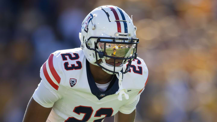 Nov 25, 2023; Tempe, Arizona, USA; An Arizona State Sun Devils player reflects in the helmet visor of Arizona Wildcats cornerback Tacario Davis (23) in the first half of the Territorial Cup at Mountain America Stadium. Mandatory Credit: Mark J. Rebilas-USA TODAY Sports