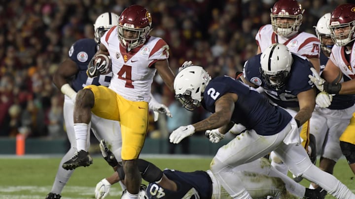 Jan 2, 2017; Pasadena, CA, USA; USC Trojans running back Ronald Jones II (4) runs against Penn State Nittany Lions linebacker Jason Cabinda (40) and safety Marcus Allen (2) during the fourth quarter of the 2017 Rose Bowl game at Rose Bowl.