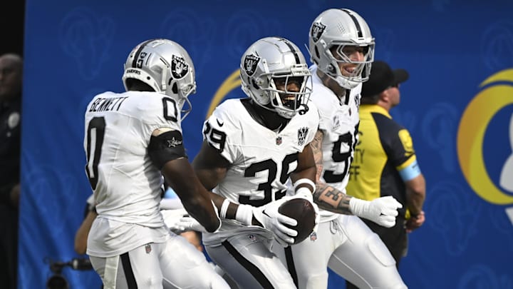 Oct 20, 2024; Inglewood, California, USA; Las Vegas Raiders cornerback Nate Hobbs (39) celebrates intercepting a Los Angeles Rams quarterback Matthew Stafford (not pictured) pass during the third quarter at SoFi Stadium. Left is Las Vegas Raiders cornerback Jakorian Bennett (0), right is defensive end Maxx Crosby (98). Mandatory Credit: Robert Hanashiro-Imagn Images