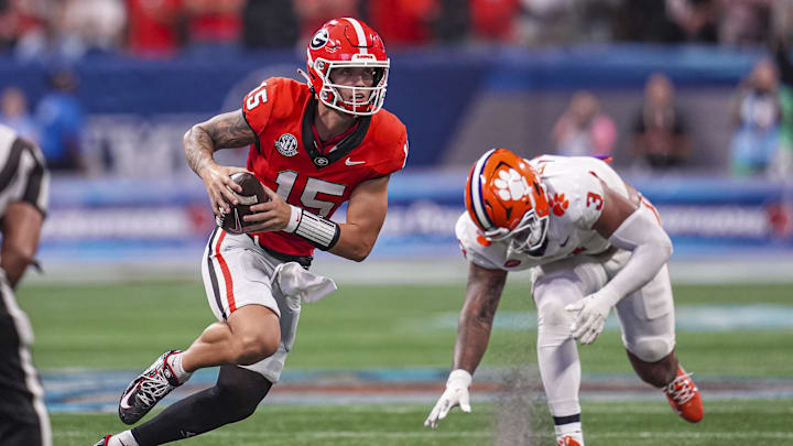 Aug 31, 2024; Atlanta, Georgia, USA; Georgia Bulldogs quarterback Carson Beck (15) runs past Clemson Tigers defensive end T.J. Parker (3) during the second half at Mercedes-Benz Stadium. Mandatory Credit: Dale Zanine-USA TODAY Sports
