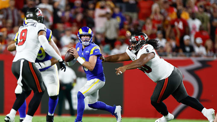 Nov 6, 2022; Tampa, Florida, USA; Los Angeles Rams quarterback Matthew Stafford (9) scrambles with the ball while under pressure from Tampa Bay Buccaneers defensive tackle Vita Vea (50) during the third quarter at Raymond James Stadium. Mandatory Credit: Douglas DeFelice-Imagn Images