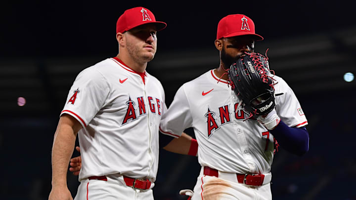 Apr 23, 2024; Anaheim, California, USA; Los Angeles Angels right fielder Jo Adell (7) meets with center fielder Mike Trout (27) following the top of the seventh inning against the Baltimore Orioles at Angel Stadium. Mandatory Credit: Gary A. Vasquez-Imagn Images