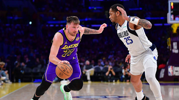 Feb 25, 2025; Los Angeles, California, USA; Los Angeles Lakers guard Luka Doncic (77) dribbles the ball against Dallas Mavericks forward P.J. Washington (25) during the second half at Crypto.com Arena. Mandatory Credit: Gary A. Vasquez-Imagn Images