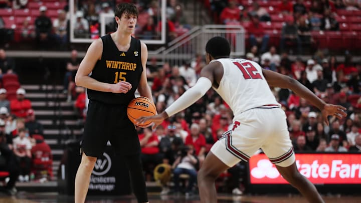 Dec 28, 2025; Lubbock, Texas, USA;  Winthrop Eagles forward Tommy Kamarad (15) dribbles the ball against Texas Tech Red Raiders guard Donovan Atwell (12) in the second half at United Supermarkets Arena. Mandatory Credit: Michael C. Johnson-Imagn Images