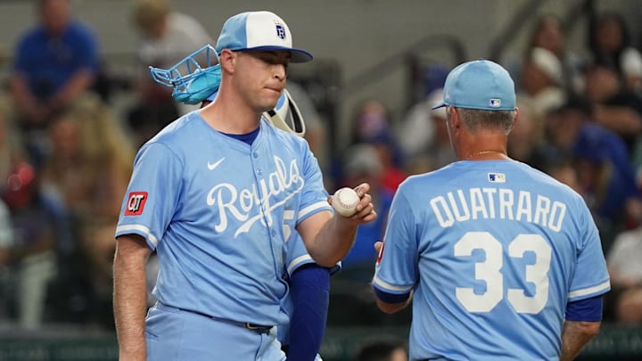 Jun 18, 2025; Arlington, Texas, USA; Kansas City Royals pitcher Kris Bubic (50) hands the baseball to manager Matt Quatraro (33) as he leaves the game during the sixth inning against the Texas Rangers at Globe Life Field. Mandatory Credit: Raymond Carlin III-Imagn Images