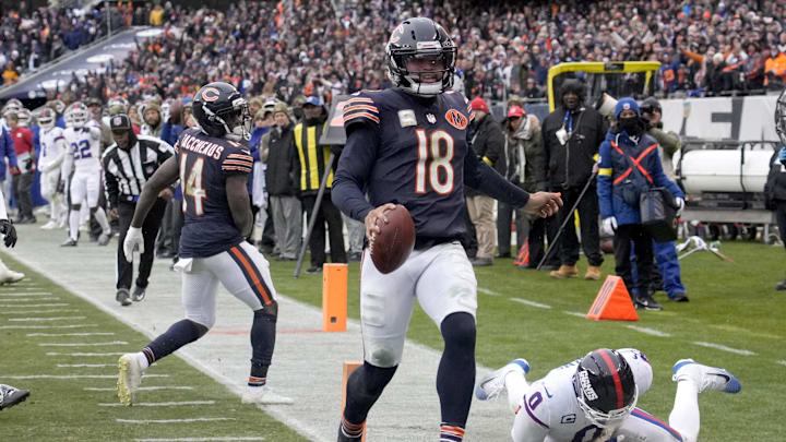 Nov 9, 2025; Chicago, Illinois, USA; Chicago Bears quarterback Caleb Williams (18) scores the game-winning touchdown against New York Giants linebacker Brian Burns (0) during the fourth quarter at Soldier Field. Mandatory Credit: David Banks-Imagn Images
