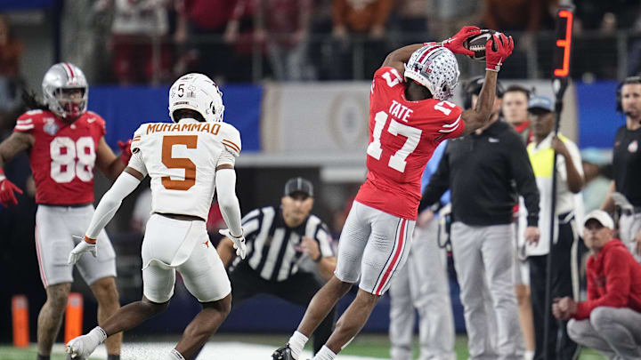 Ohio State Buckeyes wide receiver Carnell Tate (17) makes a sideline catch in front of Texas Longhorns defensive back Malik Muhammad (5) during the first half of the Cotton Bowl Classic College Football Playoff semifinal game at AT&T Stadium in Arlington, Texas on Jan. 10, 2025.