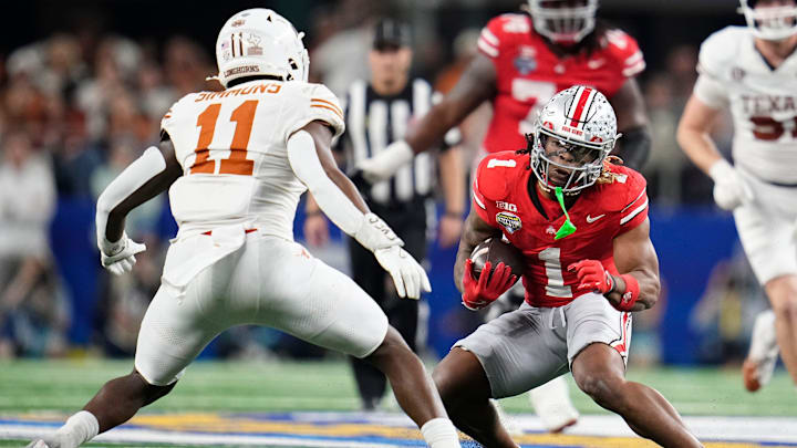 Ohio State Buckeyes running back Quinshon Judkins (1) runs toward Texas Longhorns linebacker Colin Simmons (11) during the second half of the Cotton Bowl Classic College Football Playoff semifinal game at AT&T Stadium in Arlington, Texas on Jan. 10, 2025. Ohio State won 28-14.