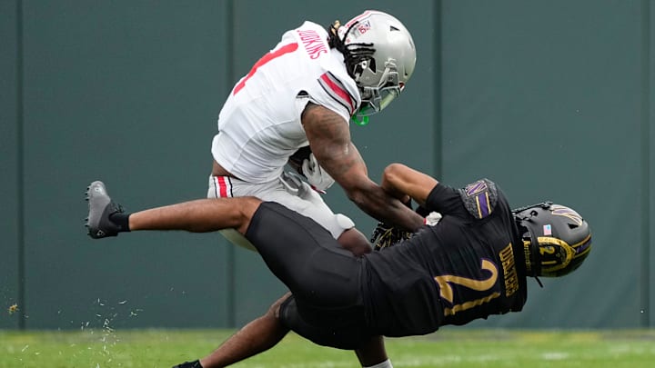 Ohio State Buckeyes running back Quinshon Judkins (1) sheds Northwestern Wildcats defensive back Damon Walters (21) as he runs during the first half of the NCAA football game at Wrigley Field in Chicago on Saturday, Nov. 16, 2024.