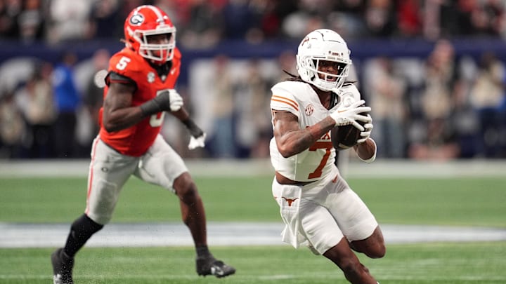 Dec 7, 2024; Atlanta, GA, USA; Texas Longhorns wide receiver Isaiah Bond (7) makes a catch past Georgia Bulldogs linebacker Raylen Wilson (5) during the first half in the 2024 SEC Championship game at Mercedes-Benz Stadium. 