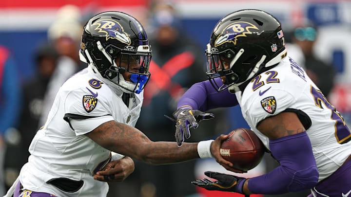 Dec 15, 2024; East Rutherford, New Jersey, USA; Baltimore Ravens quarterback Lamar Jackson (8) hands off to running back Derrick Henry (22) during the first quarter at MetLife Stadium. Mandatory Credit: Vincent Carchietta-Imagn Images